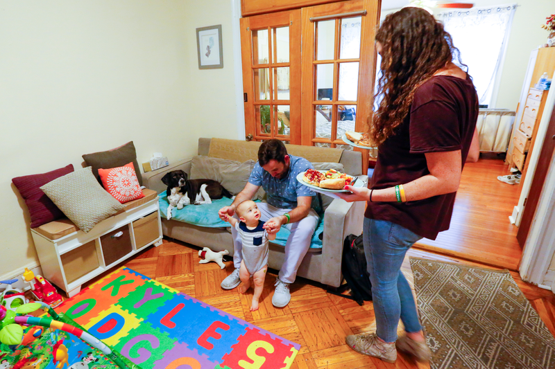 Jenna greeting Artie, Scout, and Kyle with dinner in hand.